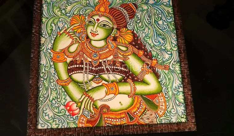 DEVI in the Vine Grove — Kerala mural detail: The framed panel seen from above, the carved mosaic border catching the light
