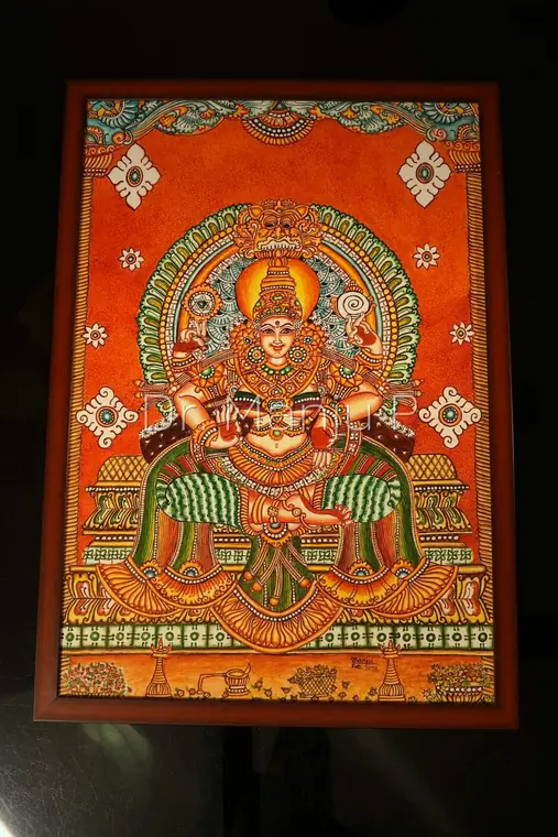 MOOKAMBIKA  Devi Enthroned Beneath the Kirtimukha — Kerala mural detail: The panel photographed close, the kirtimukha crest and peacock-green arch in full