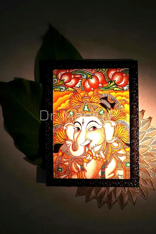 Ganapati in the Lotus Light — Kerala mural painting on canvas by Dr. Manju P: A small panel of Lord Ganesha against a golden ground, in a woven dark frame