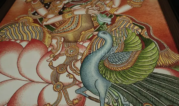 Saraswati on the Lotus — Kerala mural detail: Raking light across the lotus and the peacock's green-gold wing
