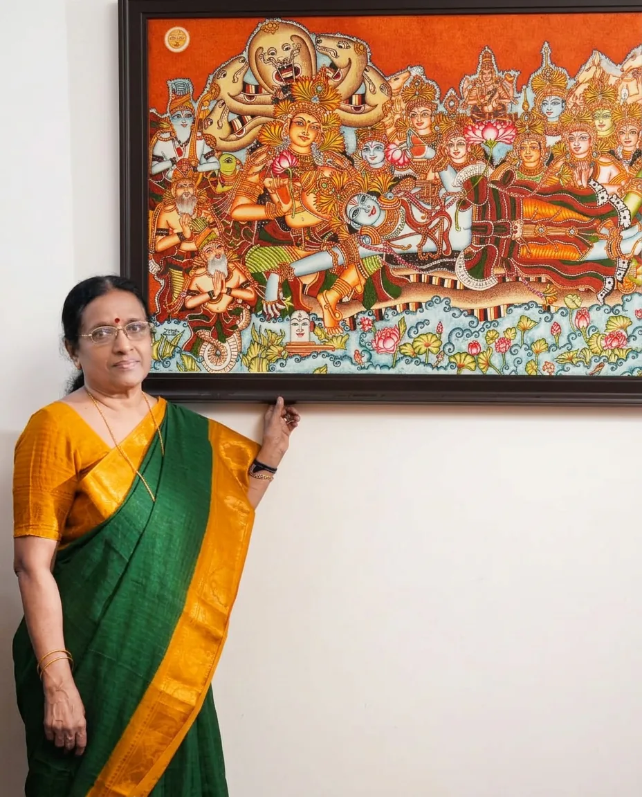 Kerala mural artist Dr. Manju P beside her completed Anantasayanam mural painting